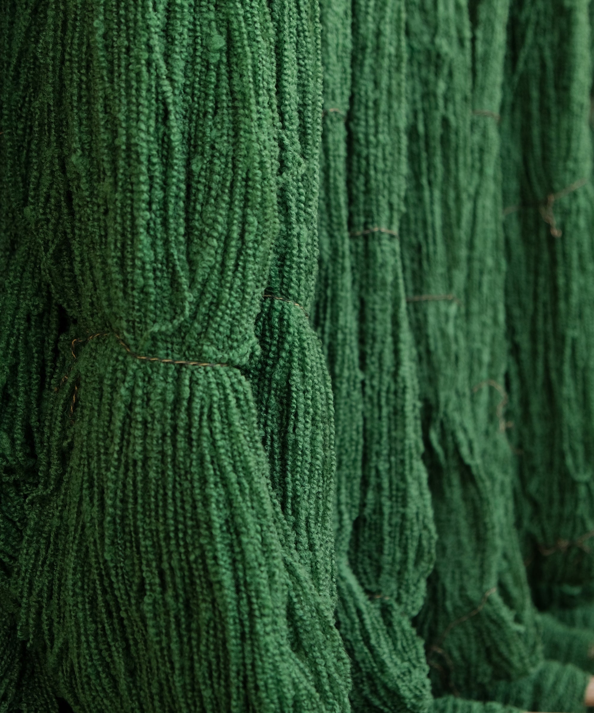 Cooper's cormo boucle yarn in artichoke green, drying.