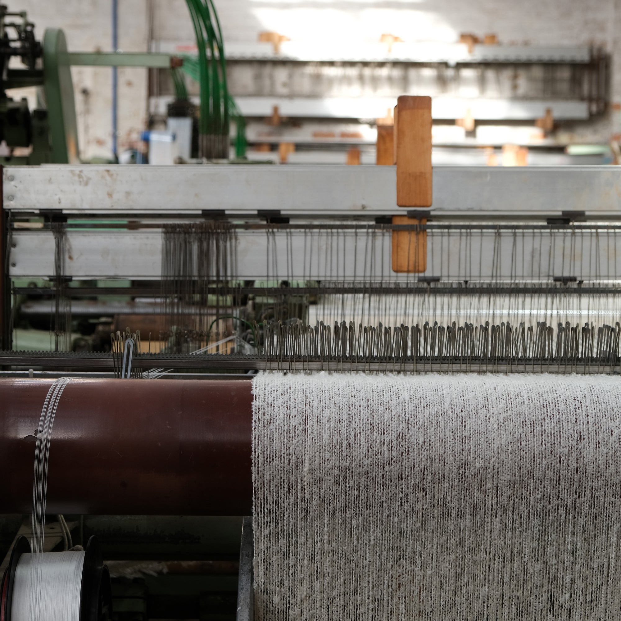 Natural Cooper's cormo boucle yarn on the loom.