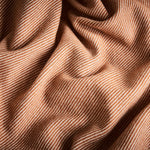 A close up of the flint blanket in terracotta showing the chunky twill contrast weave.
