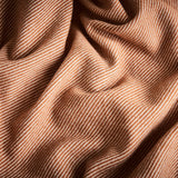 A close up of the flint blanket in terracotta showing the chunky twill contrast weave.