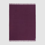A full view of the essential throw in solid aubergine purple.