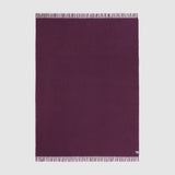A full view of the essential throw in solid aubergine purple.