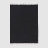 Full view of essential throw in solid charcoal black.