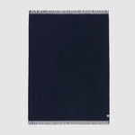 A full view of the essential throw in solid eclipse navy blue.