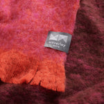 Close up of Lustre alpaca throw in ruby showing colour variation.