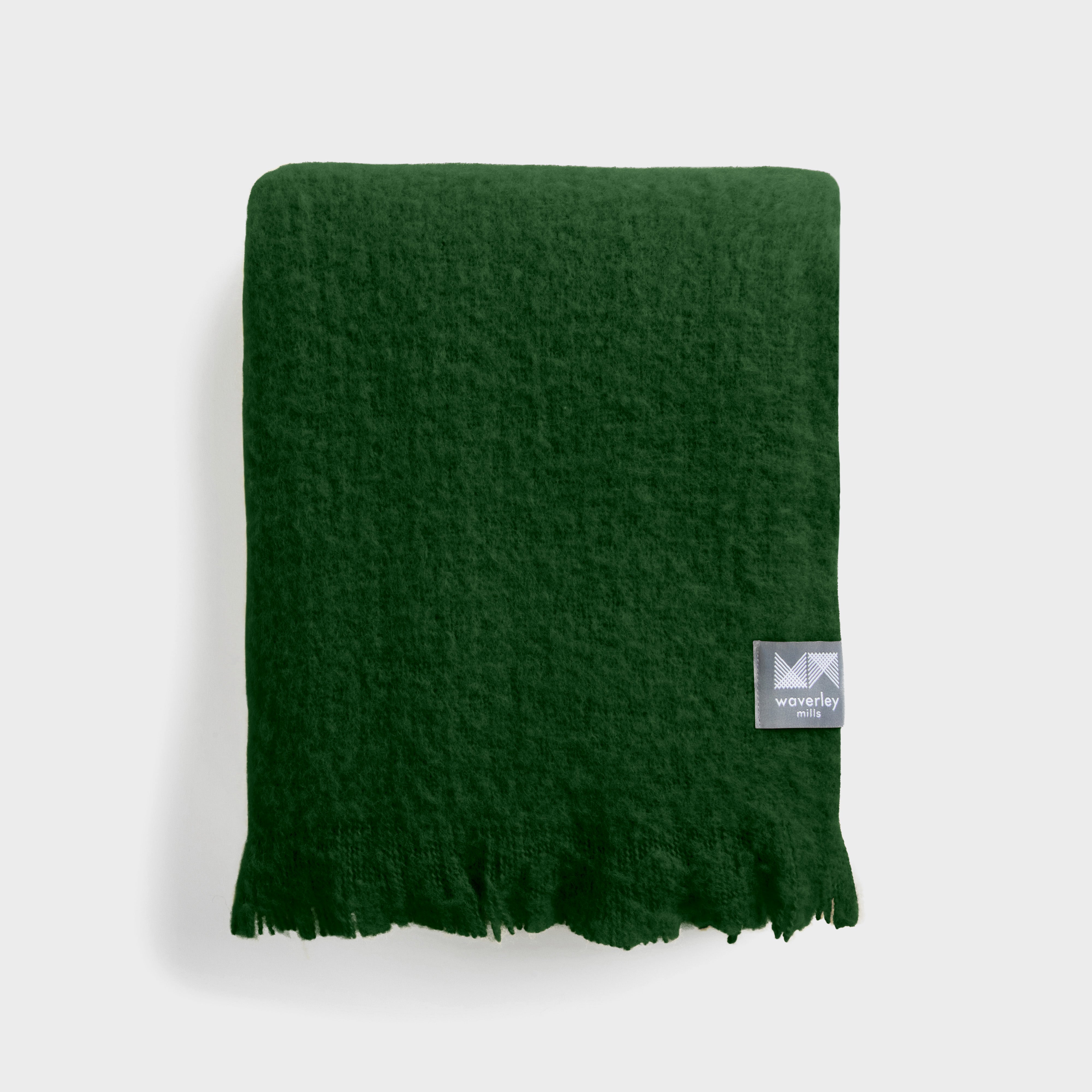 A plush folded green chroma throw.