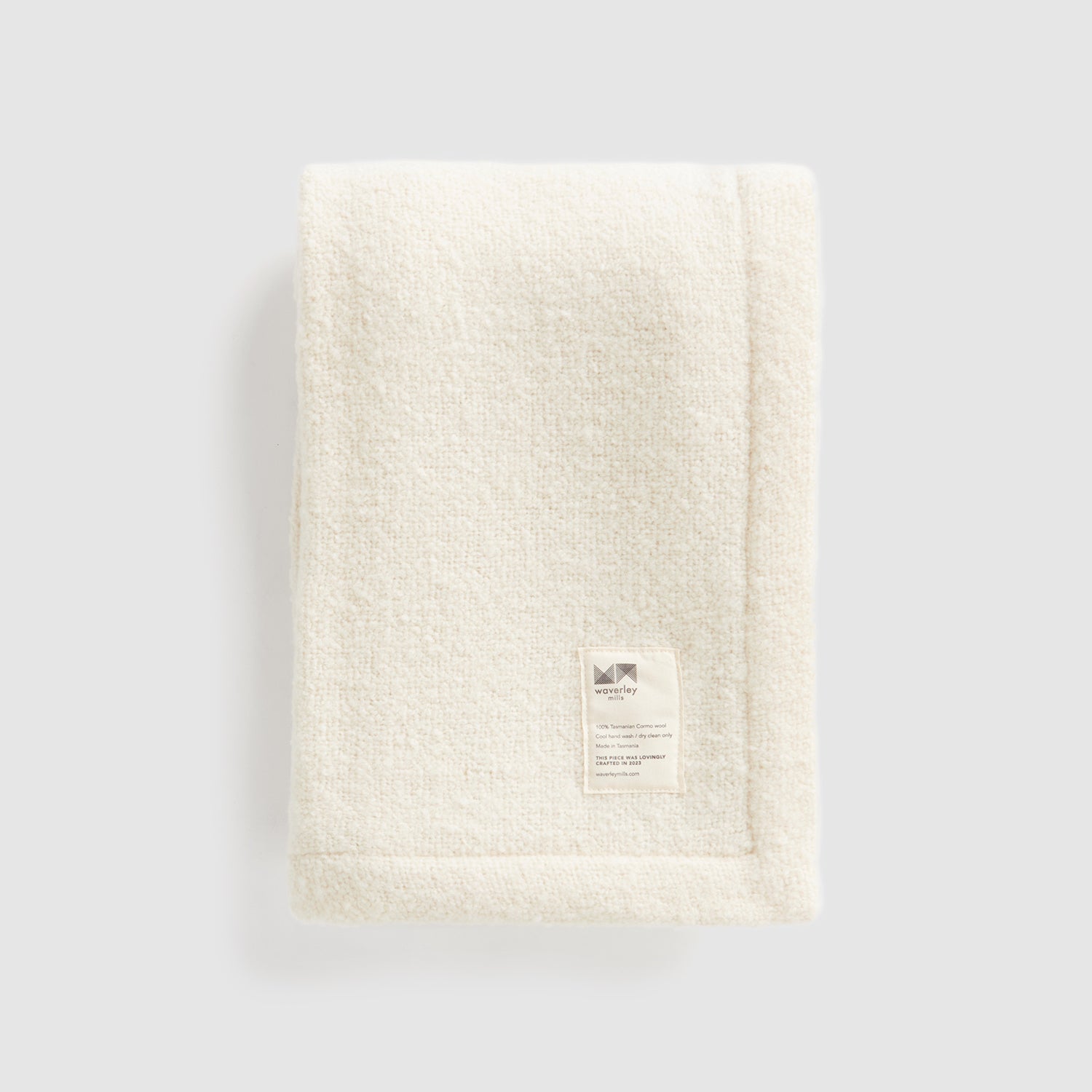 A folded cooper's cormo baby blanket in natural.