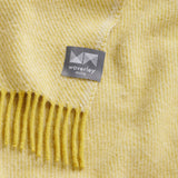 A close up of the chunky twill weave of the citrine diagonal throw. 