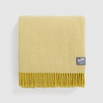 A folded diagonal throw in citrine yellow.