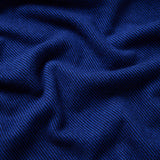 Close up of a flint blanket in cobalt showing the contrasting twill weave.