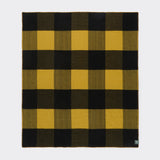 Full view of a heroes check travel rug showing bold gold and black check.