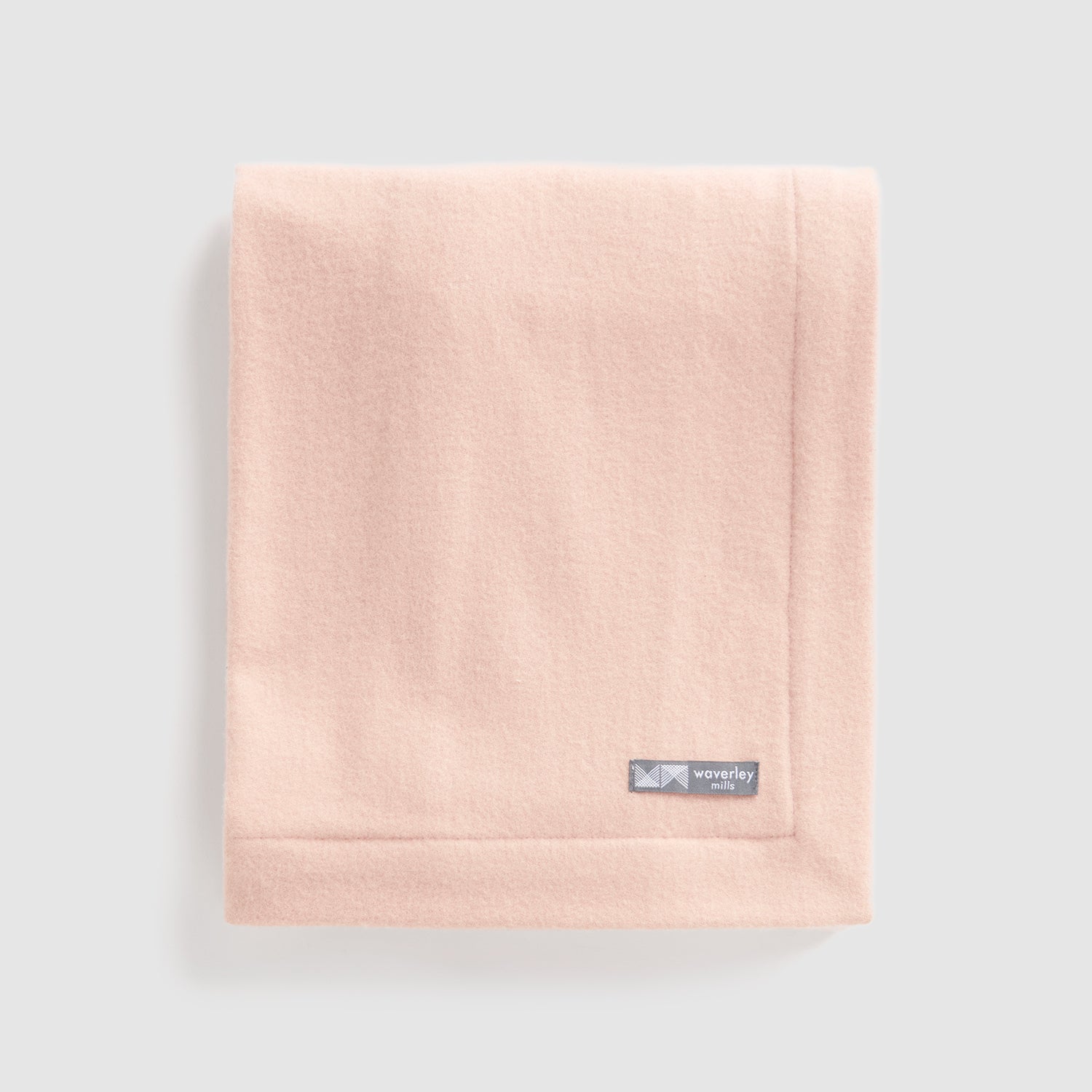 Folded merino wool baby blanket nest in pink.