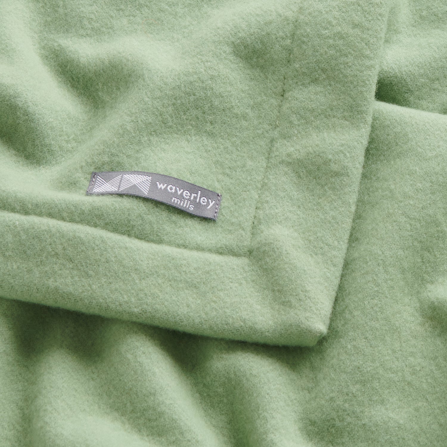 Close up of merino wool baby blanket nest in mistletoe.