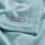 Close up of merino wool baby blanket Nest in stone blue.