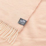A close up of a diamond knee rug in cameo rose.