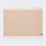 A full view of a diamond patterned knee rug in cameo rose.