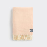 A folded knee rug in cameo rose with a diamond weave.