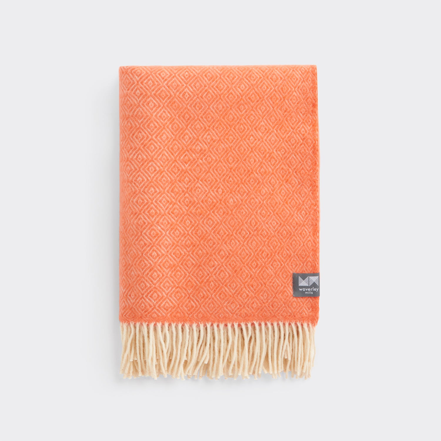 A folded diamond patterned knee rug in emberglow orange. 