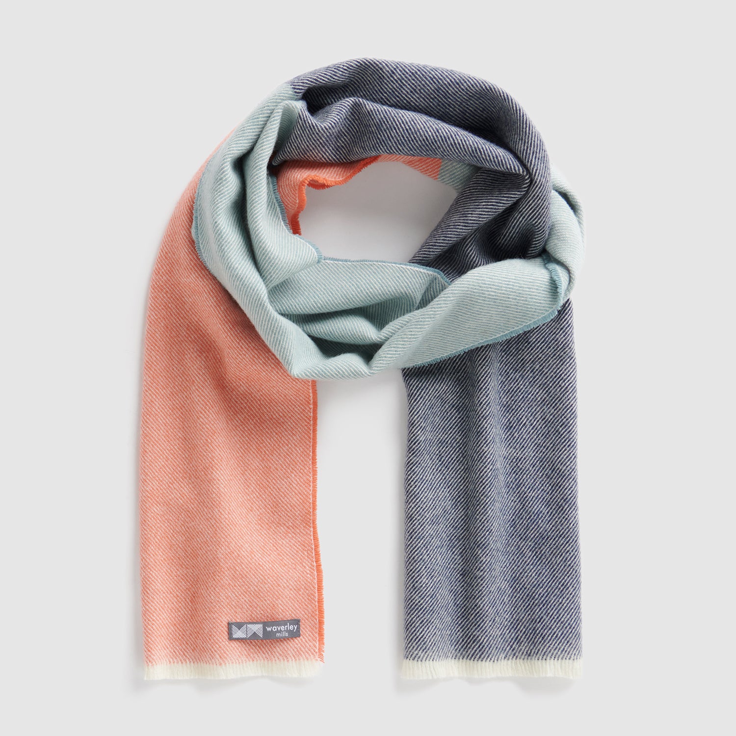 A scarf in tangerine, light blue and navy.