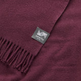 Close up of an essential throw in solid aubergine purple.
