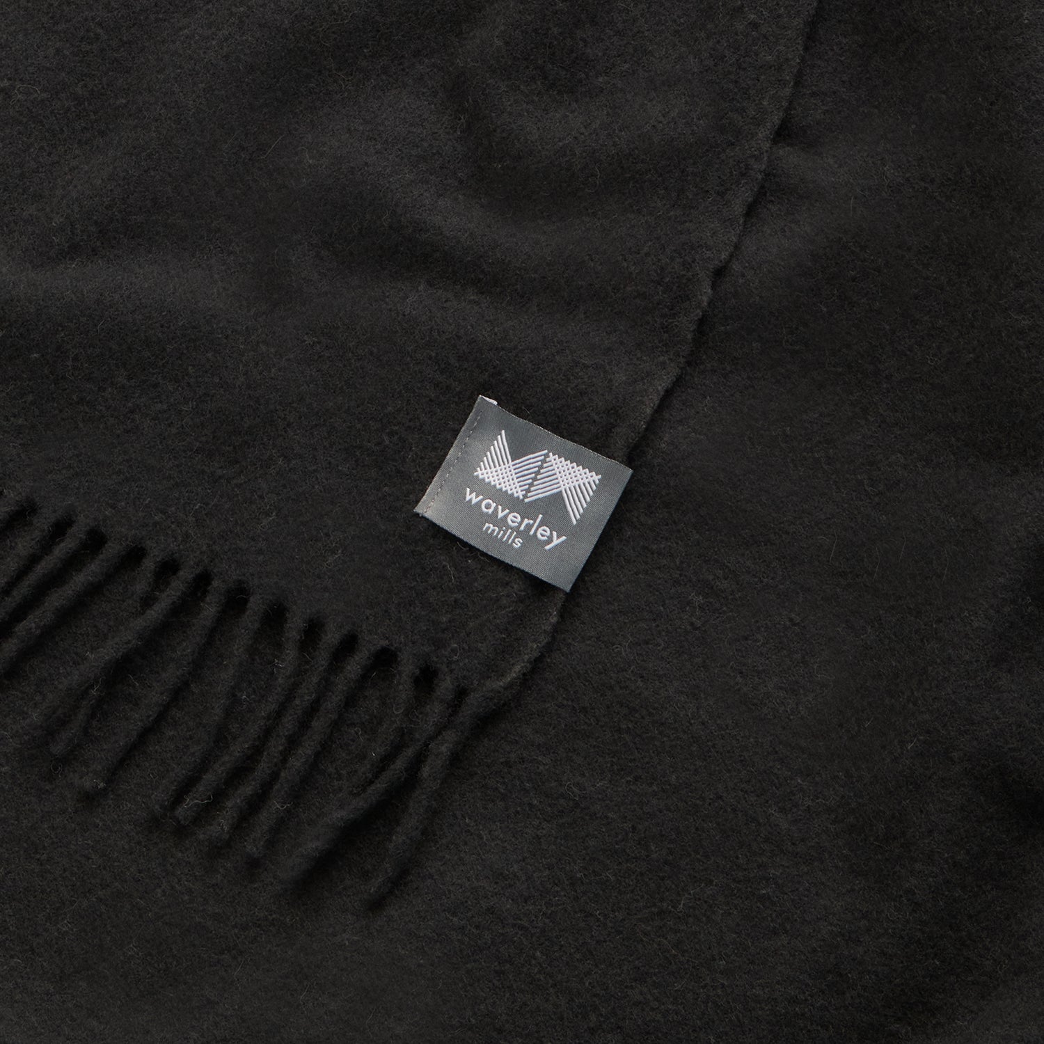 Close up of essential throw in solid charcoal black.