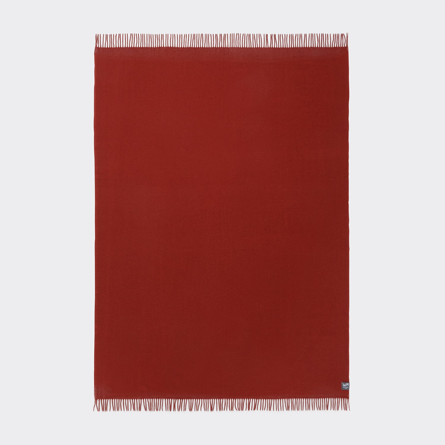 A full view of the essential throw in solid desert red.