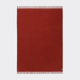 A full view of the essential throw in solid desert red.