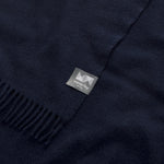 A close up of an essential throw in navy eclipse.