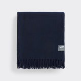 A folded essential throw in solid eclipse navy blue.
