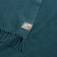 Close up of an essential throw in solid teal.
