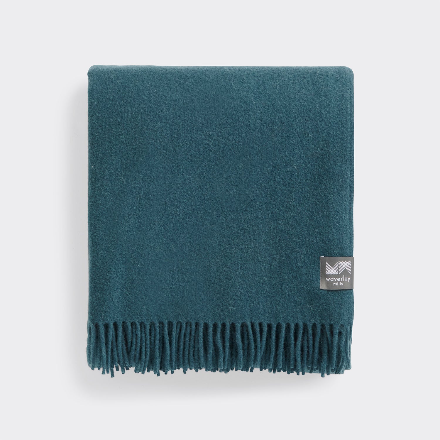 Folded essential throw in solid teal wool.