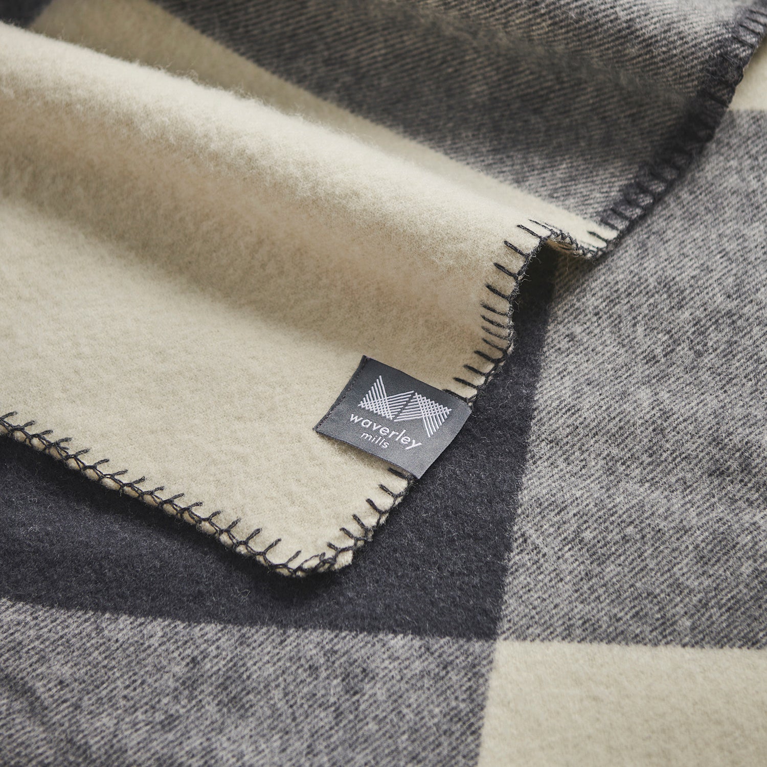 Close up of 100% merino wool blanket Smiths Lane in charcoal check.