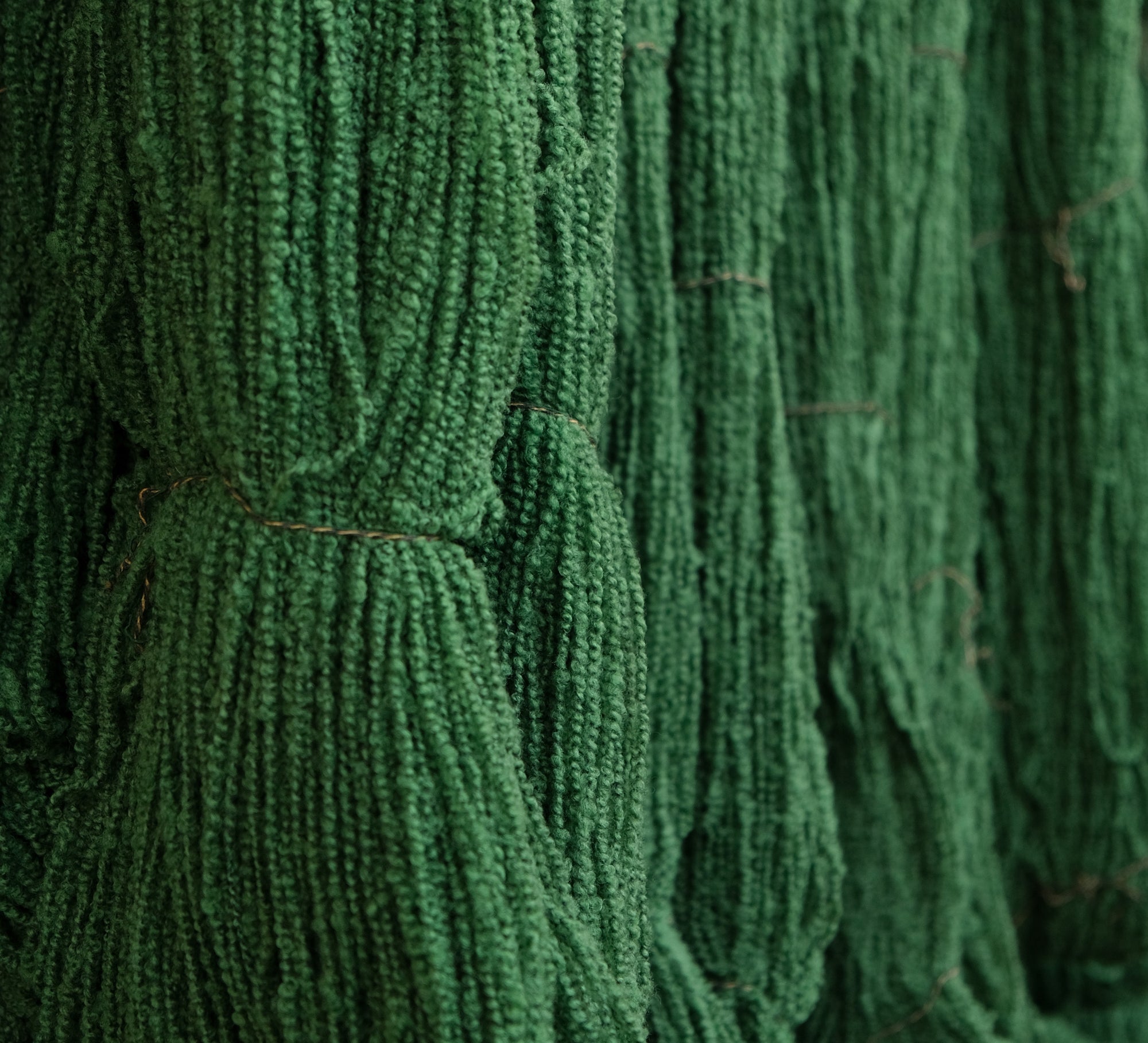 Cooper's cormo boucle yarn in artichoke green, drying.