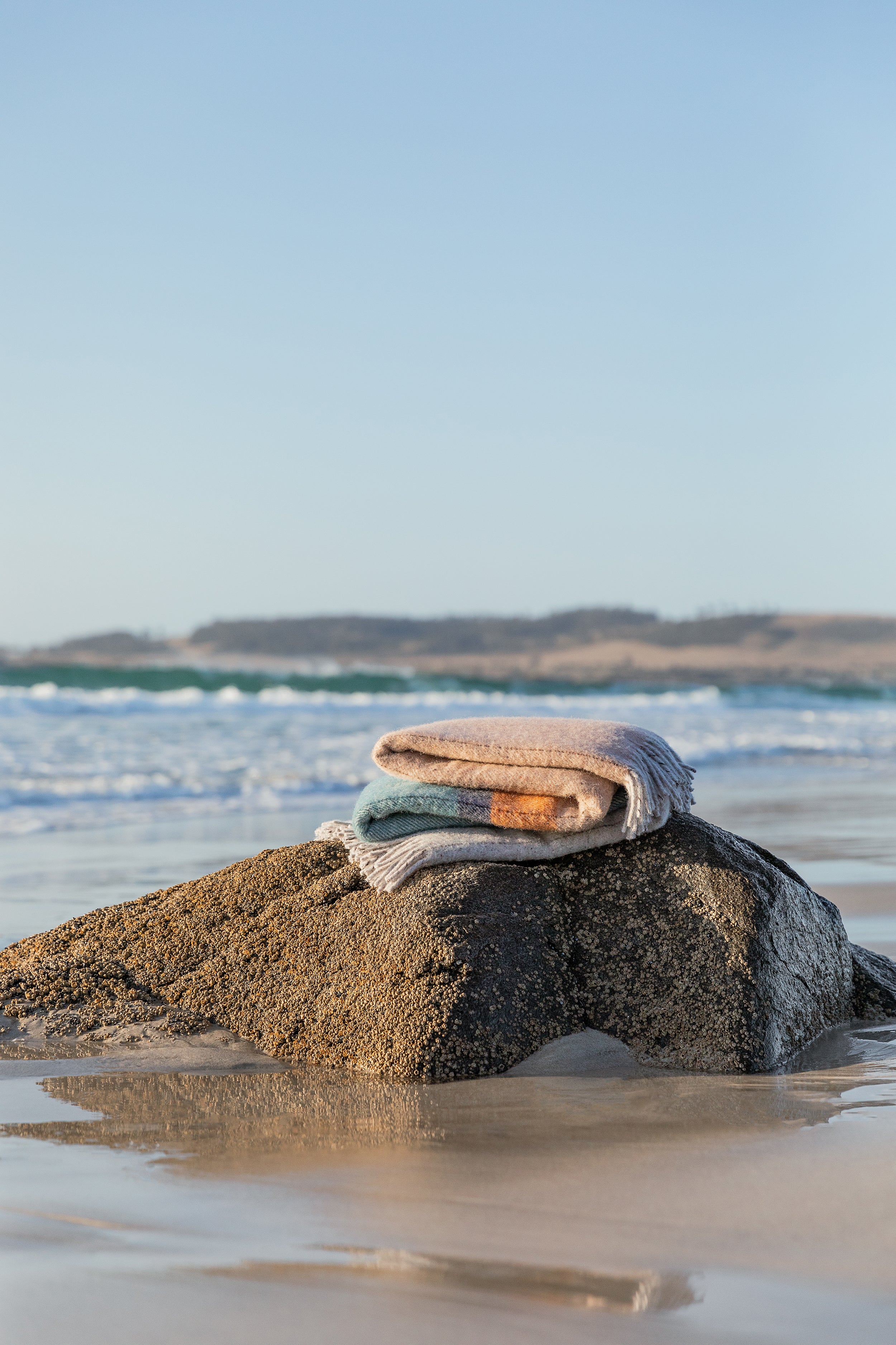 The Bay of Fires throw on a rock on the beach.