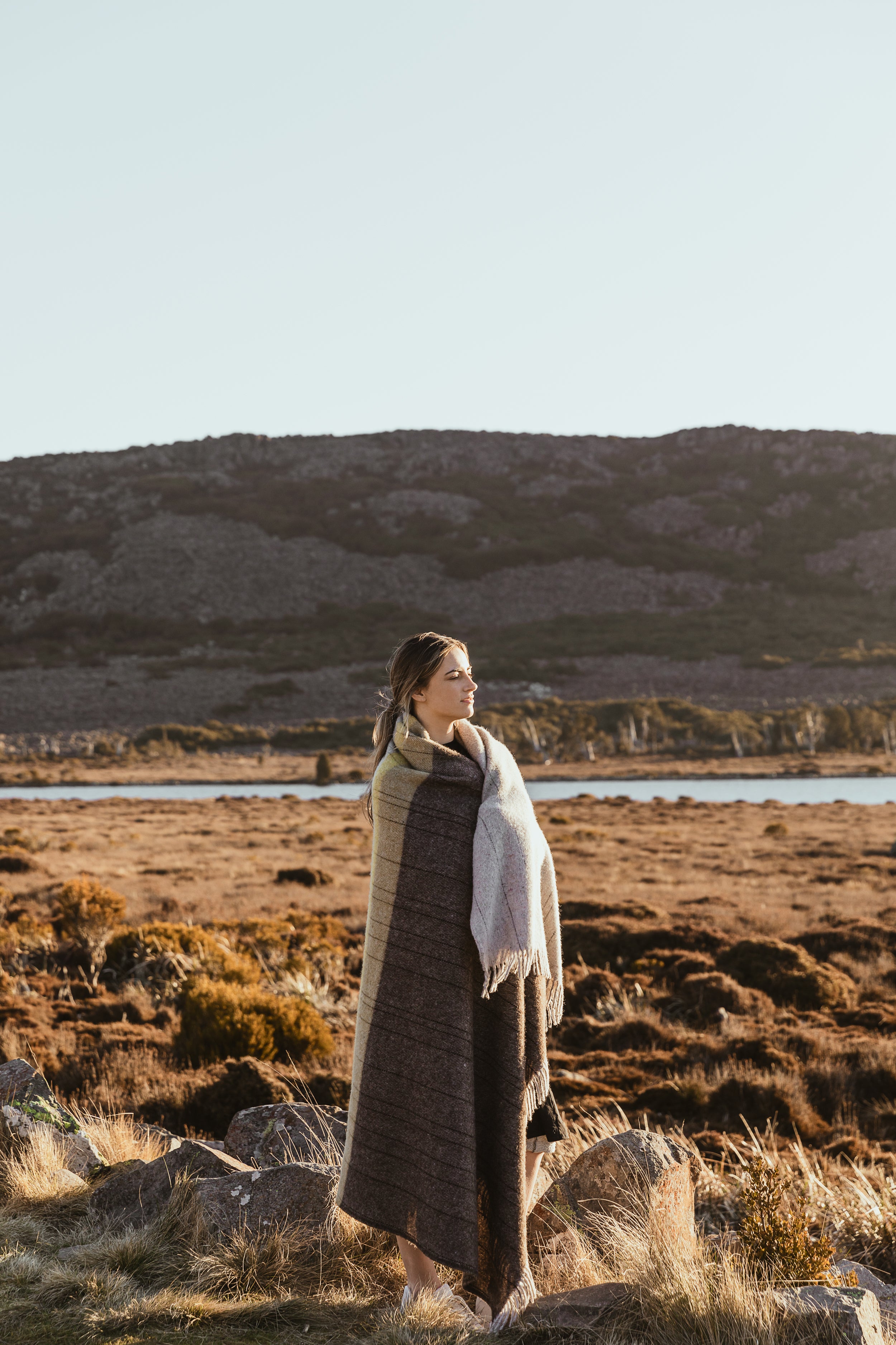 A girl wrapped in the Cradle Mountain throw on the central plateau. 