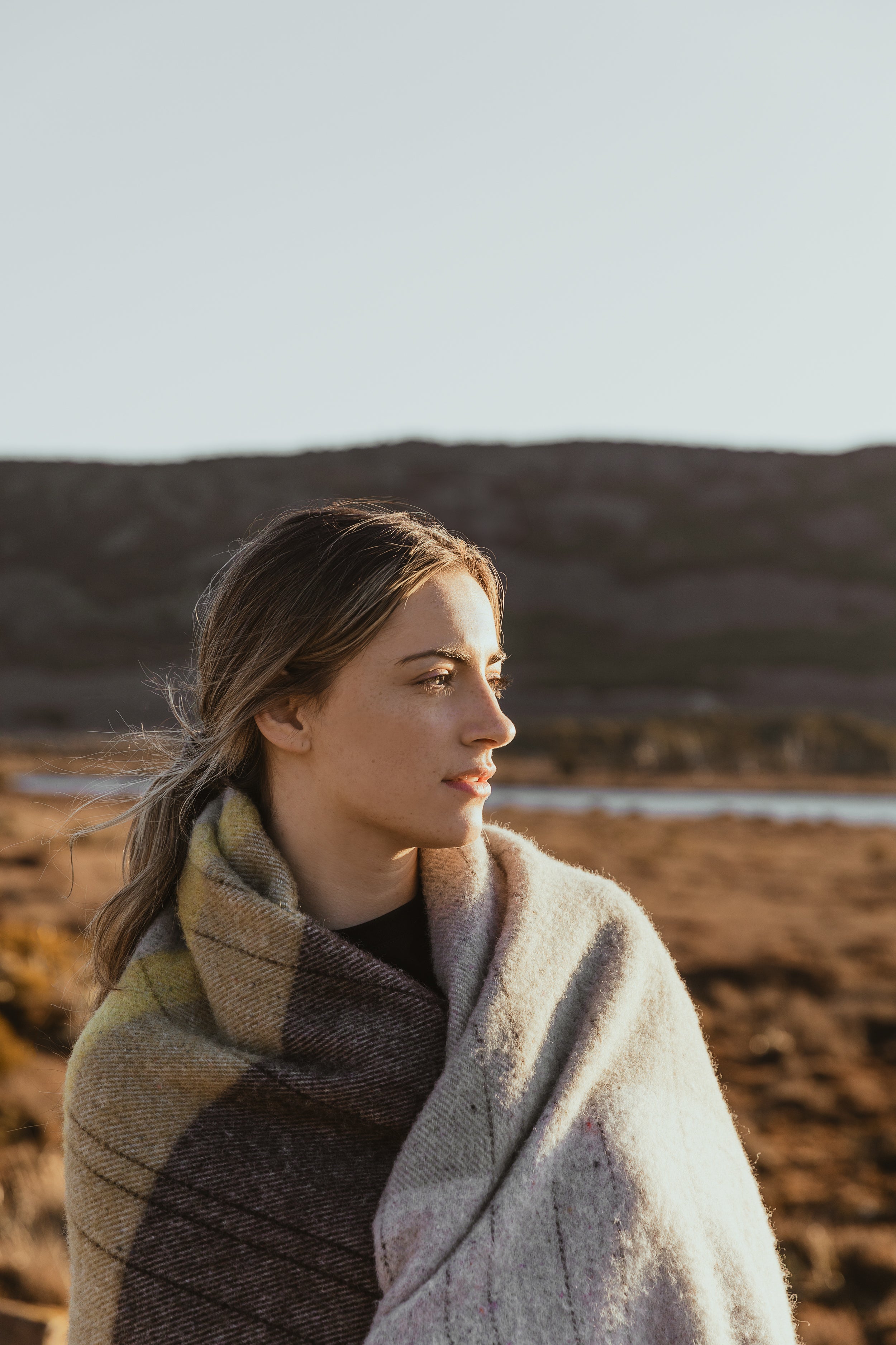 A girl with the Cradle Mountain throw around her shoulders.