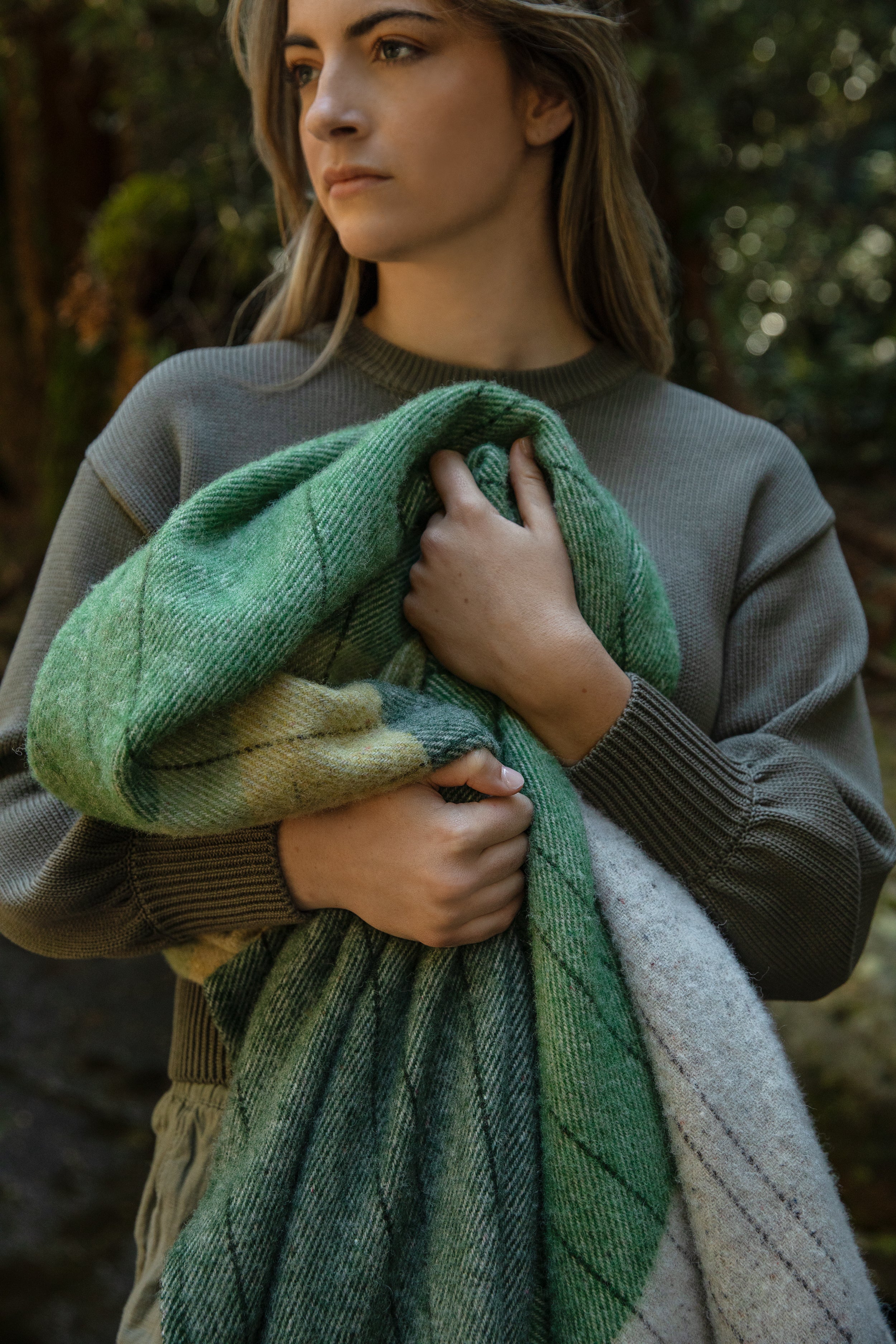 A girl holding the Tarkine Forest throw.