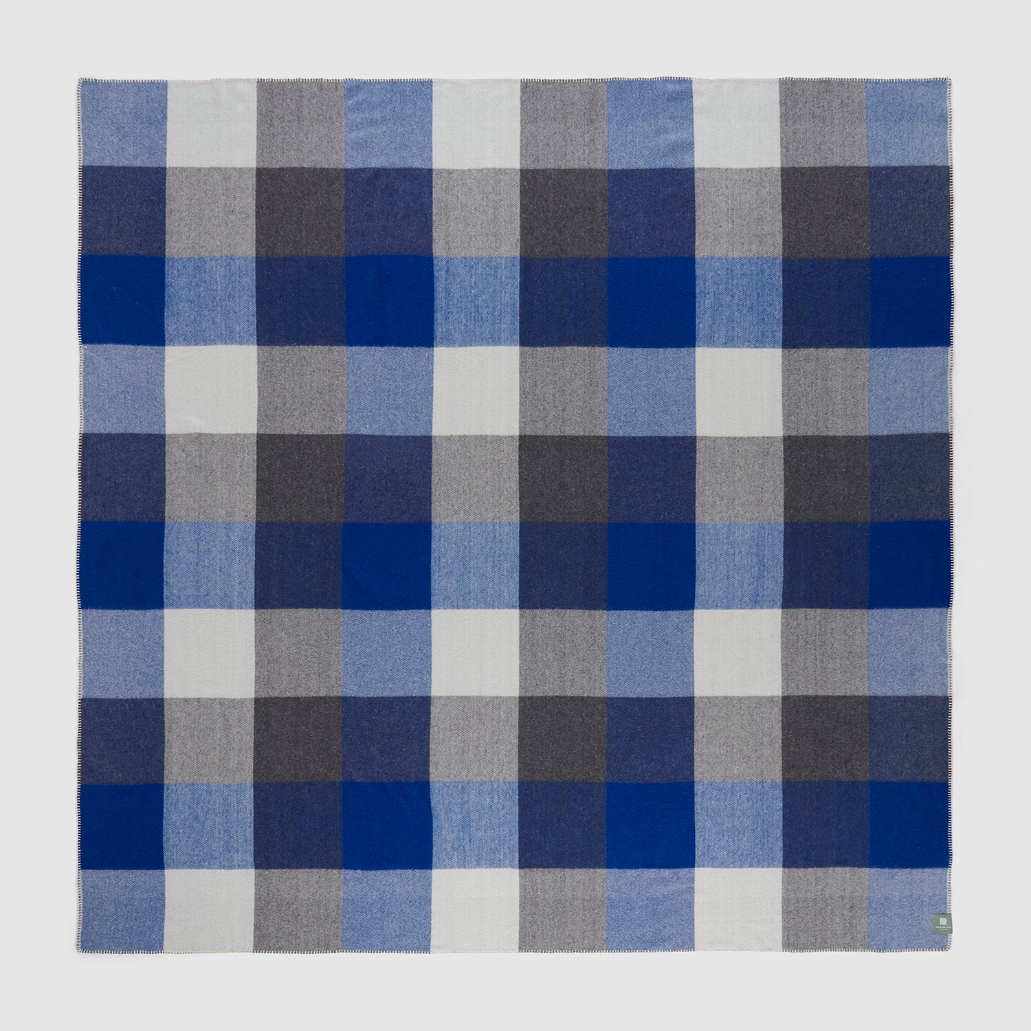 A full view of a seafarer check blanket showing the alternating checks of blue and grey.