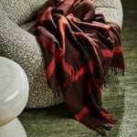 A Ravine throw in umber draped over the edge of an arm chair.