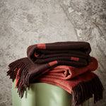 A pair of 100% merino wool throws. Featuring Ravine and Diagonal in umber.