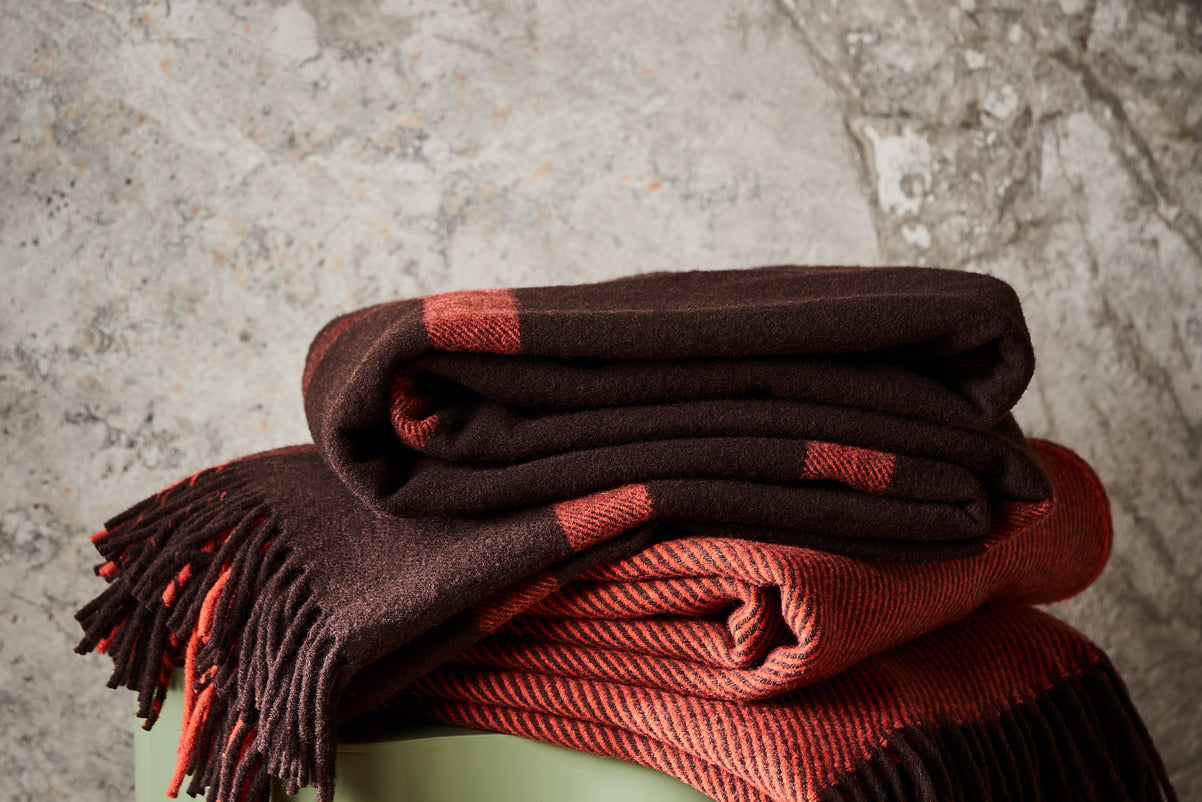 A pair of 100% merino wool throws. Featuring Ravine and Diagonal in umber.