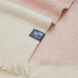 Close up of 100% alpaca stripe throw in stripes of pink and natural.