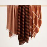 Three terracotta throws hanging together; Diagonal, Rift and Ravine.