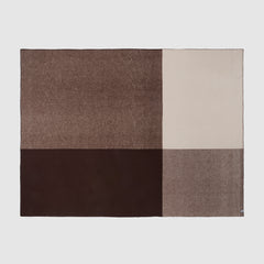 Full view of a geo blanket in umber showing the bold check pattern.