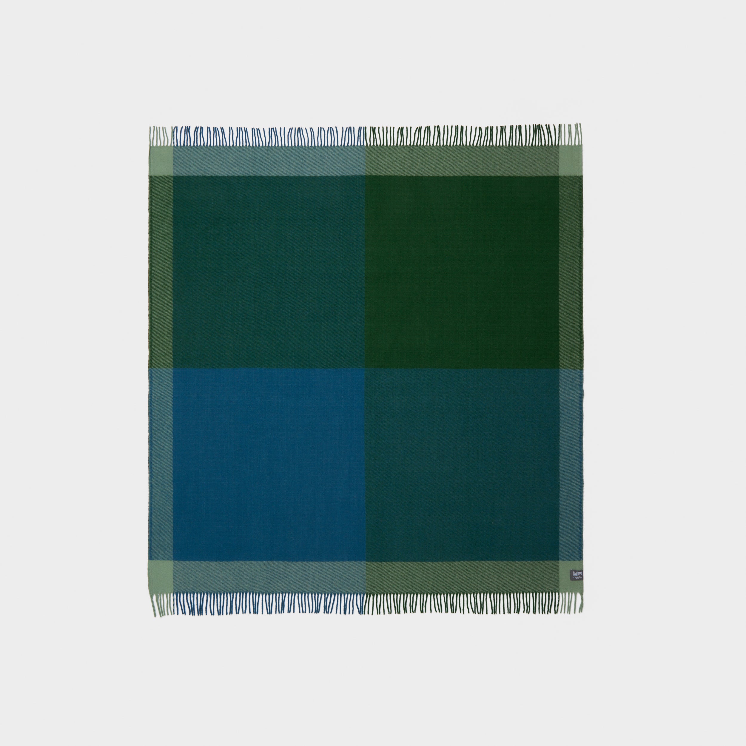 Full view of a graze picnic rug in green and blue.