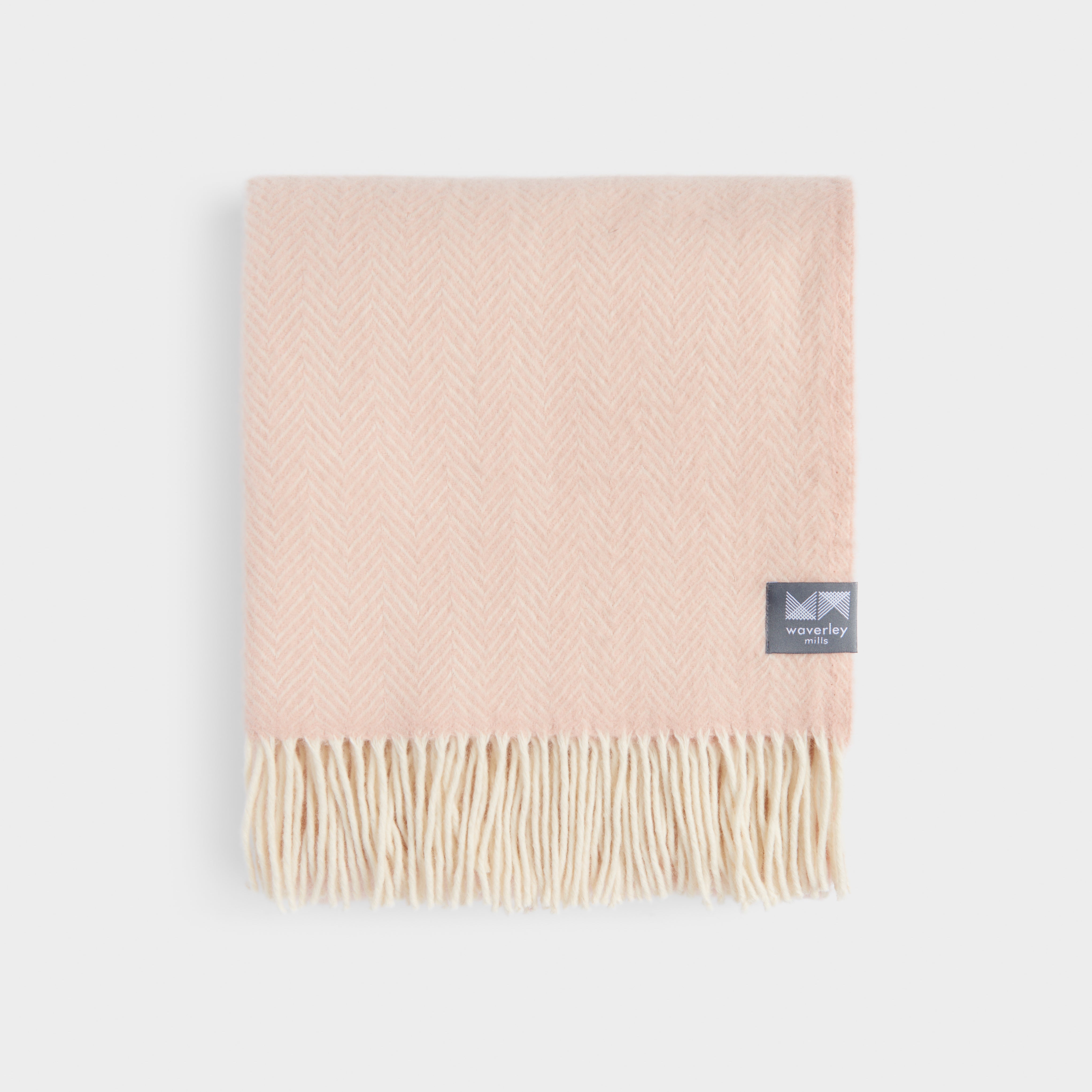 Folded cameo rose herringbone throw.