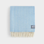 Folded pure merino wool herringbone throw in sky blue.