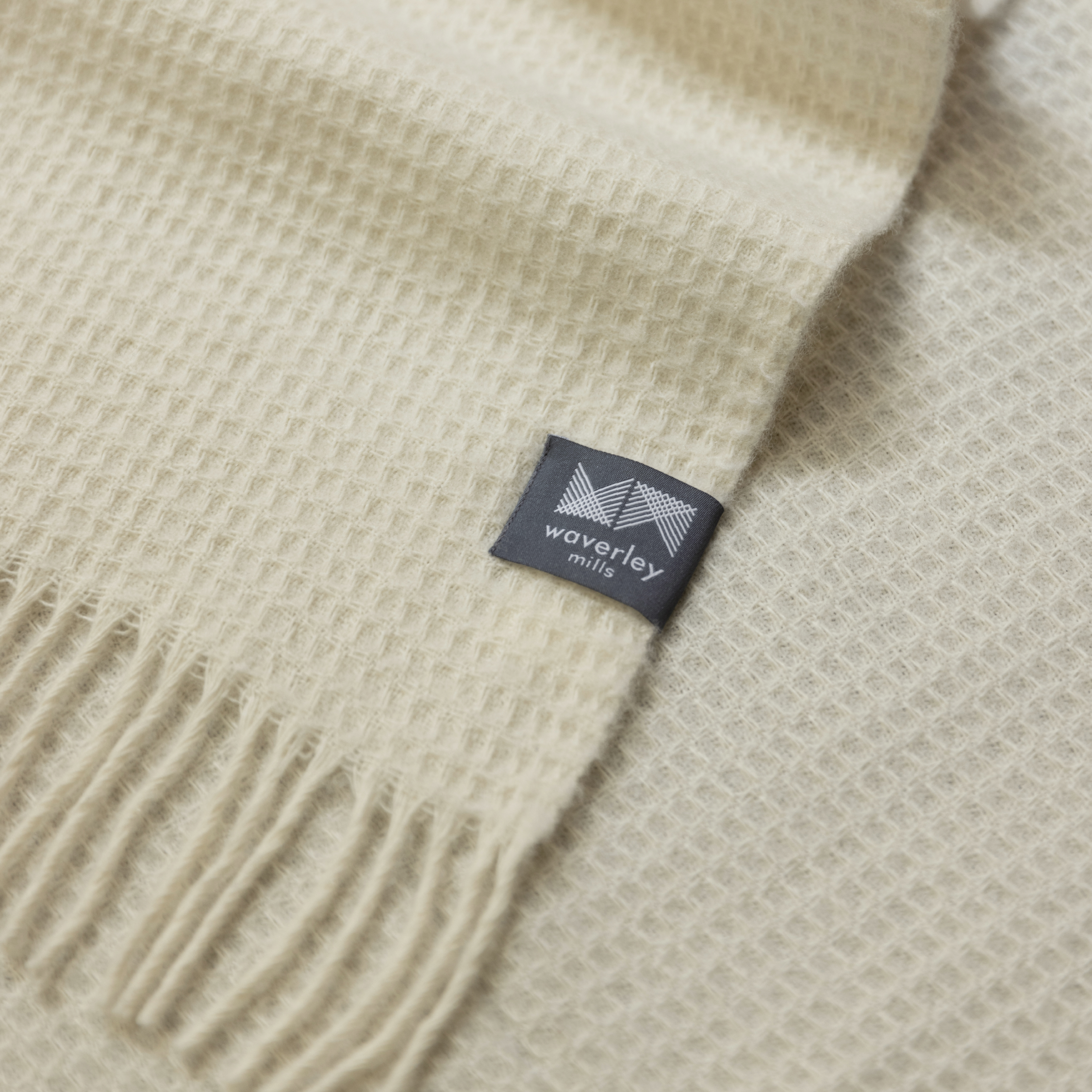 Close up of merino wool waffle throw in natural.