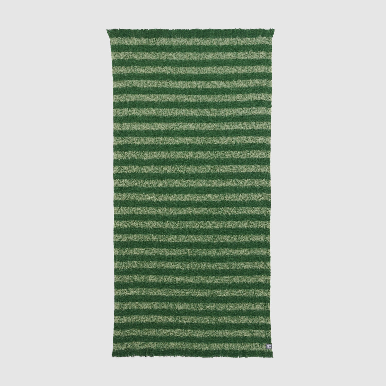 Full view of Rift throw showing dark and light green stripe pattern.