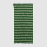 Full view of Rift throw showing dark and light green stripe pattern.